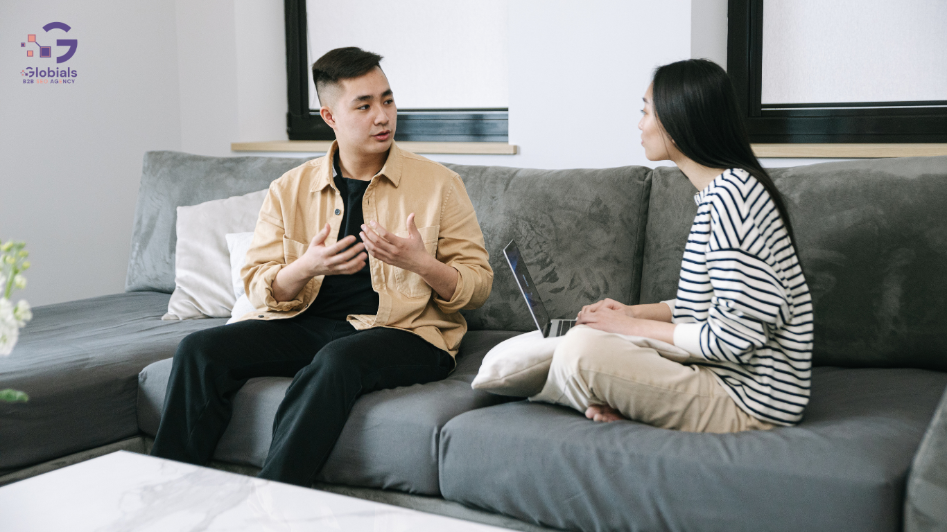 men and women sit on sofa